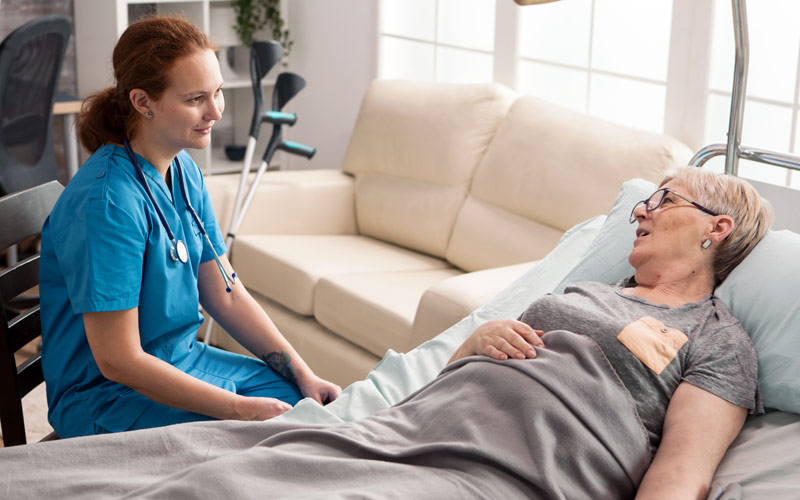 hospice nurse with patient at home